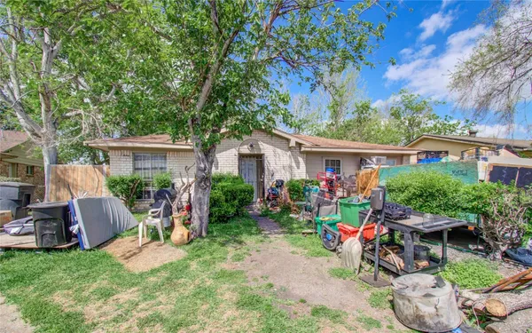 a view of a house with backyard sitting area and furniture