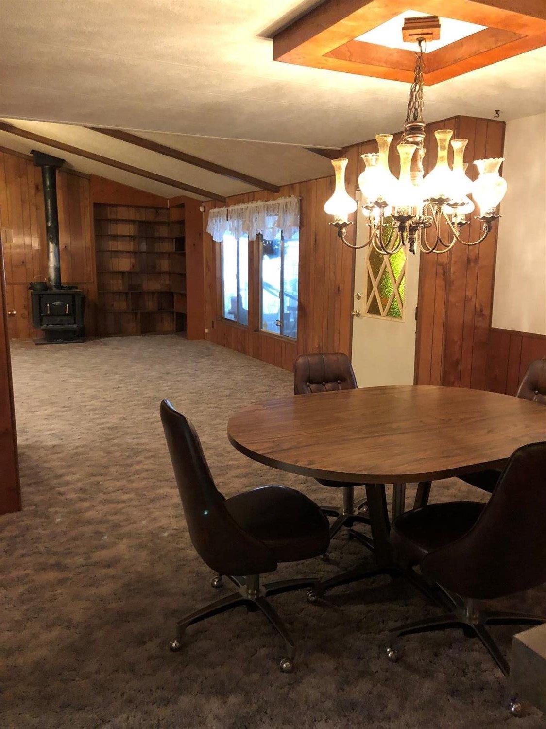 6226 East Evans Creek Road, Unit 15 Rogue River, OR 97537 - Photo 13 of 30 a view of a dining room with furniture and window
