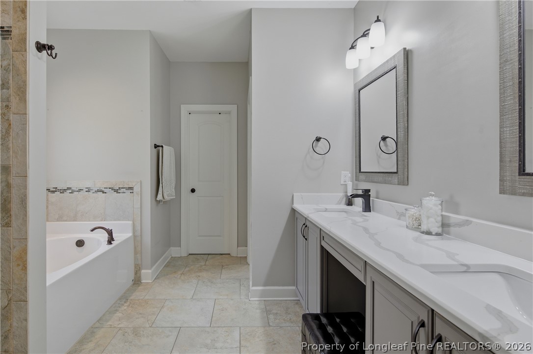148 Heatherspring Way Spring Lake, NC 28390 - Photo 29 of 50 a spacious bathroom with a tub sink and mirror