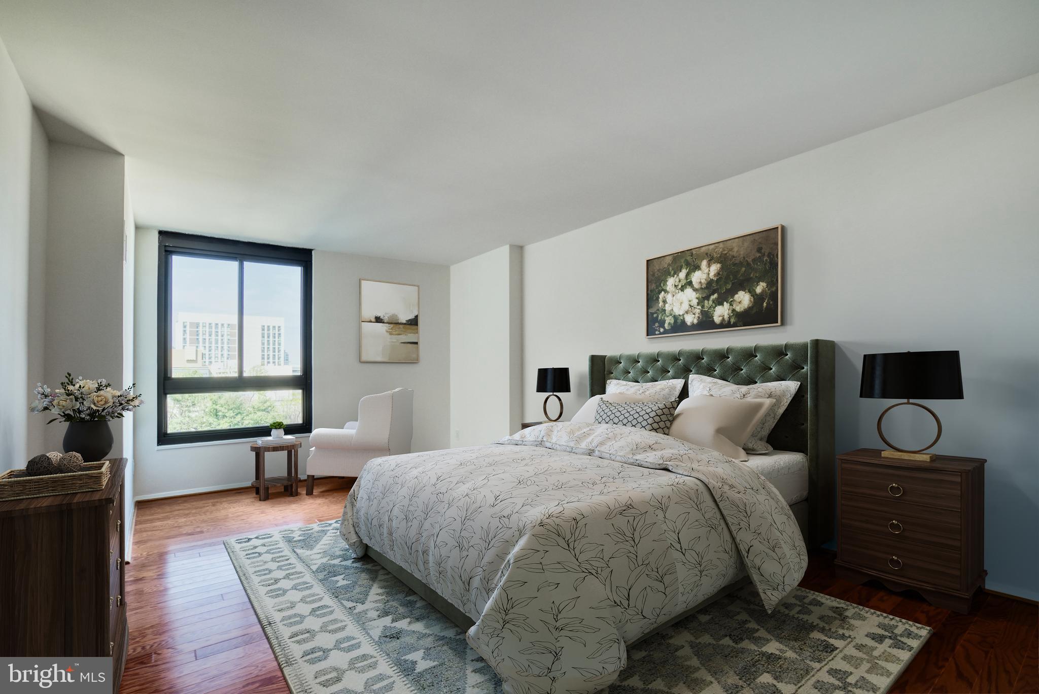 1800 Old Meadow Road, Unit 1006 McLean, VA 22102 - Photo 13 of 63 a bedroom with a bed and wooden floor