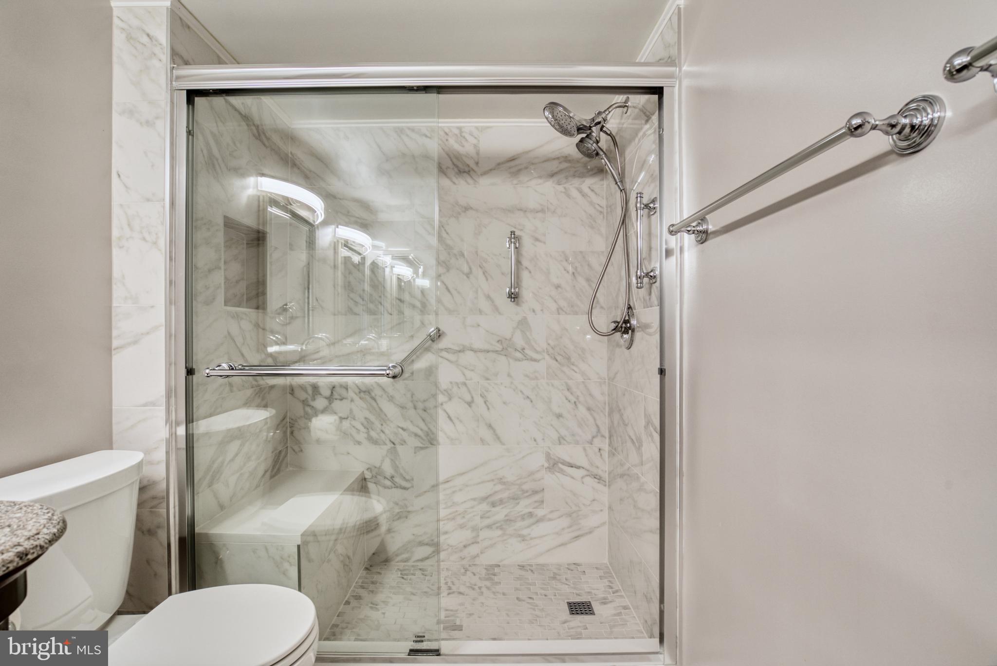 1800 Old Meadow Road, Unit 1006 McLean, VA 22102 - Photo 16 of 63 a bathroom with a shower and toilet