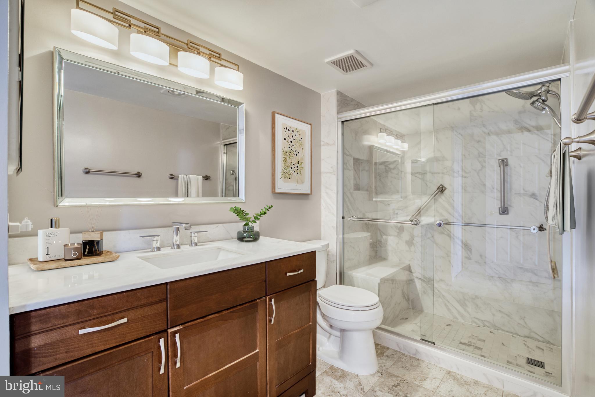 1800 Old Meadow Road, Unit 1006 McLean, VA 22102 - Photo 18 of 63 a bathroom with a shower sink vanity mirror and toilet