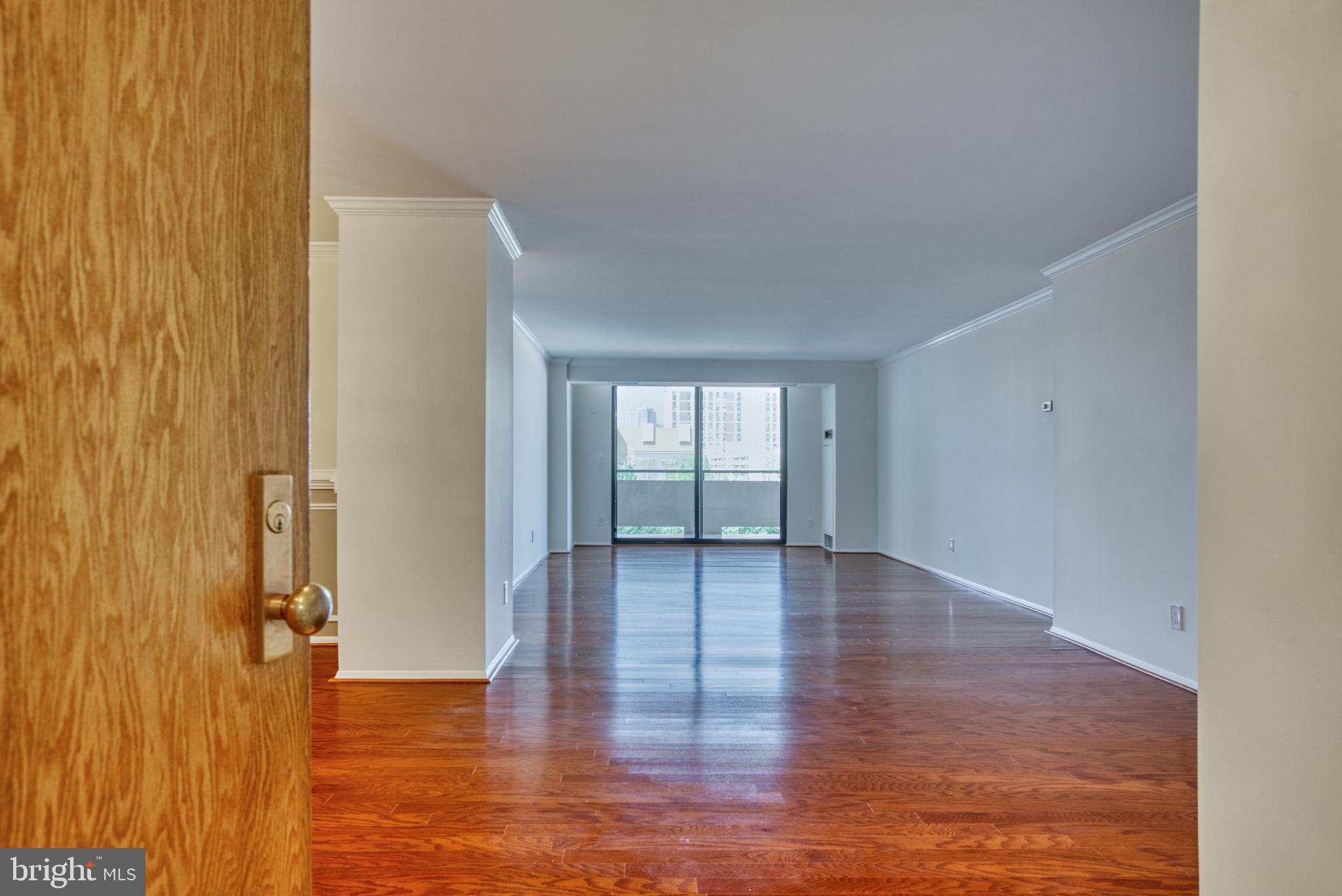 1800 Old Meadow Road, Unit 1006 McLean, VA 22102 - Photo 20 of 63 a view of an empty room with window and wooden floor