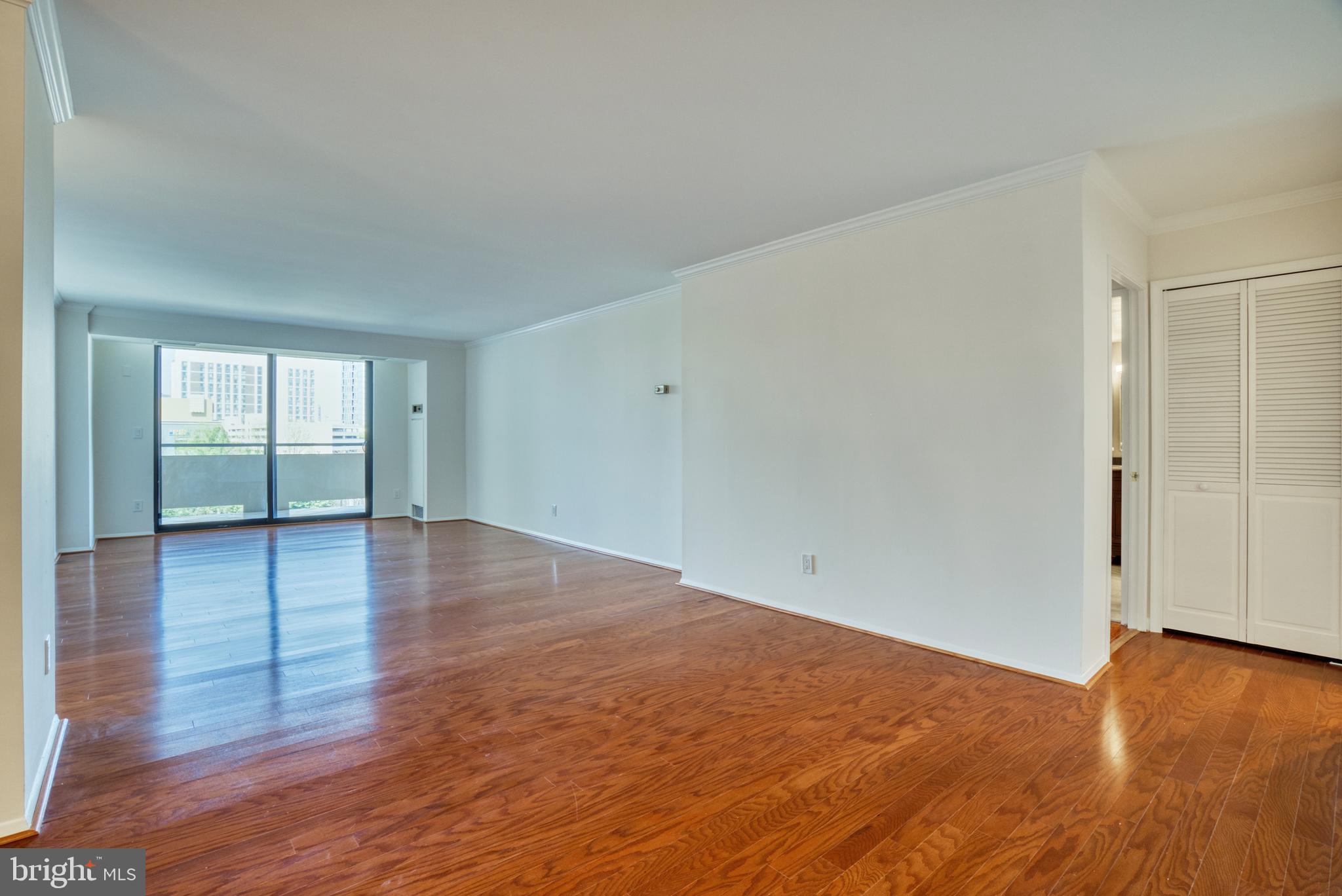 1800 Old Meadow Road, Unit 1006 McLean, VA 22102 - Photo 27 of 63 an empty room with wooden floor and windows