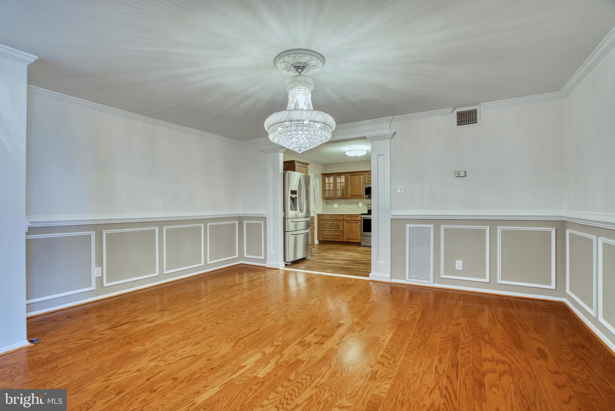 1800 Old Meadow Road, Unit 1006 McLean, VA 22102 - Photo 29 of 63 a view of an empty room with a window and wooden floor