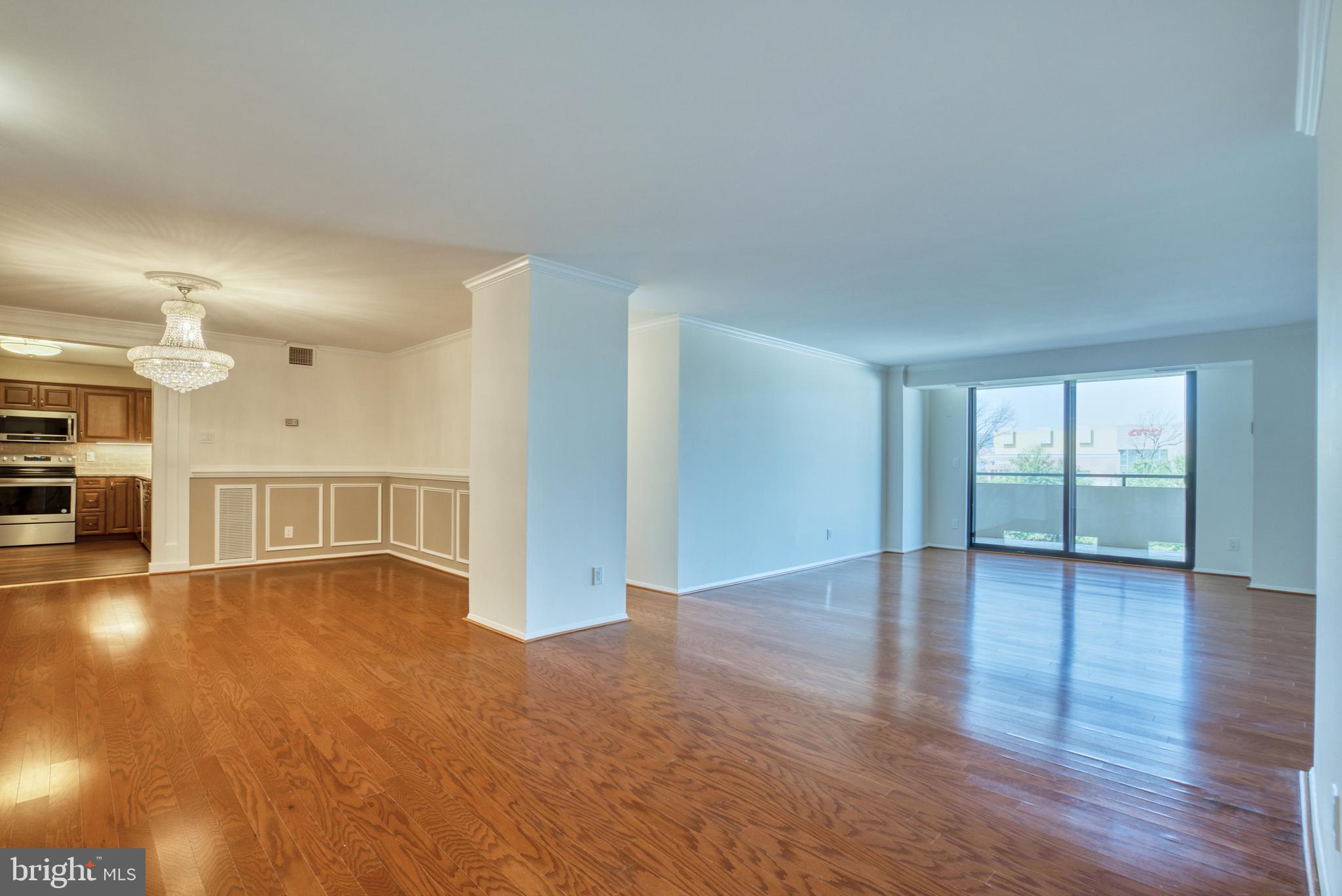 1800 Old Meadow Road, Unit 1006 McLean, VA 22102 - Photo 30 of 63 a view of an empty room with wooden floor and a window