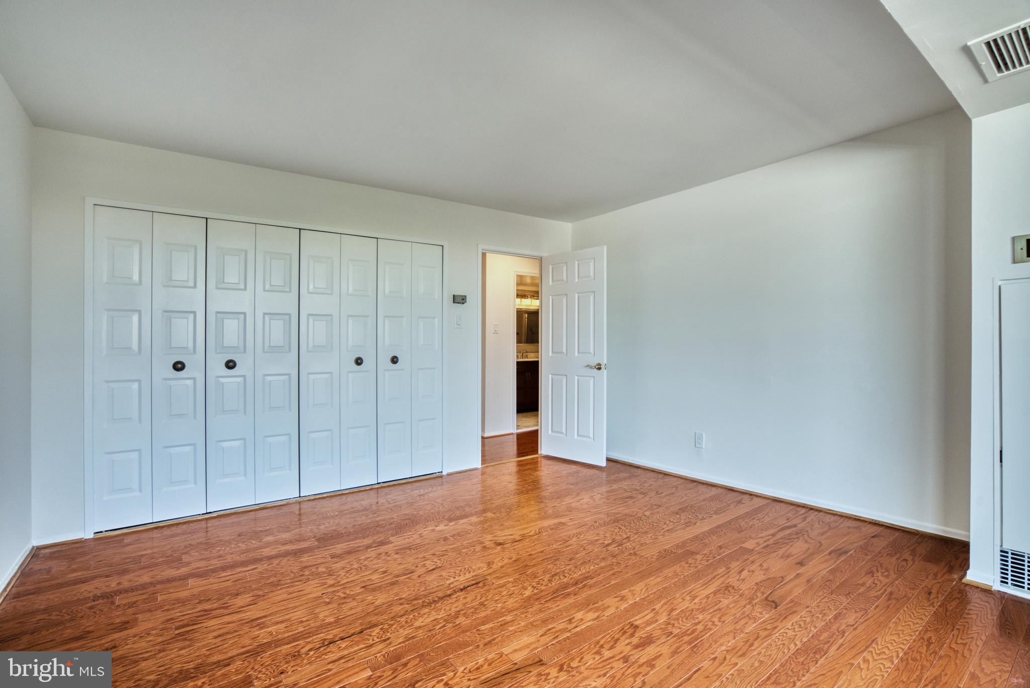 1800 Old Meadow Road, Unit 1006 McLean, VA 22102 - Photo 31 of 63 a view of an empty room with wooden floor
