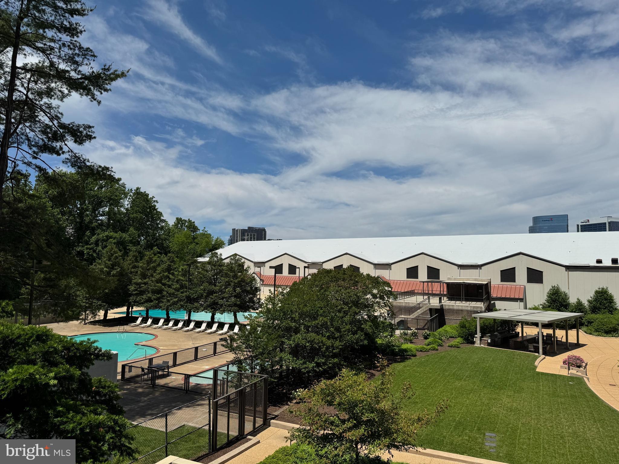 1800 Old Meadow Road, Unit 1006 McLean, VA 22102 - Photo 39 of 63 a view of yard with seating area and car parked