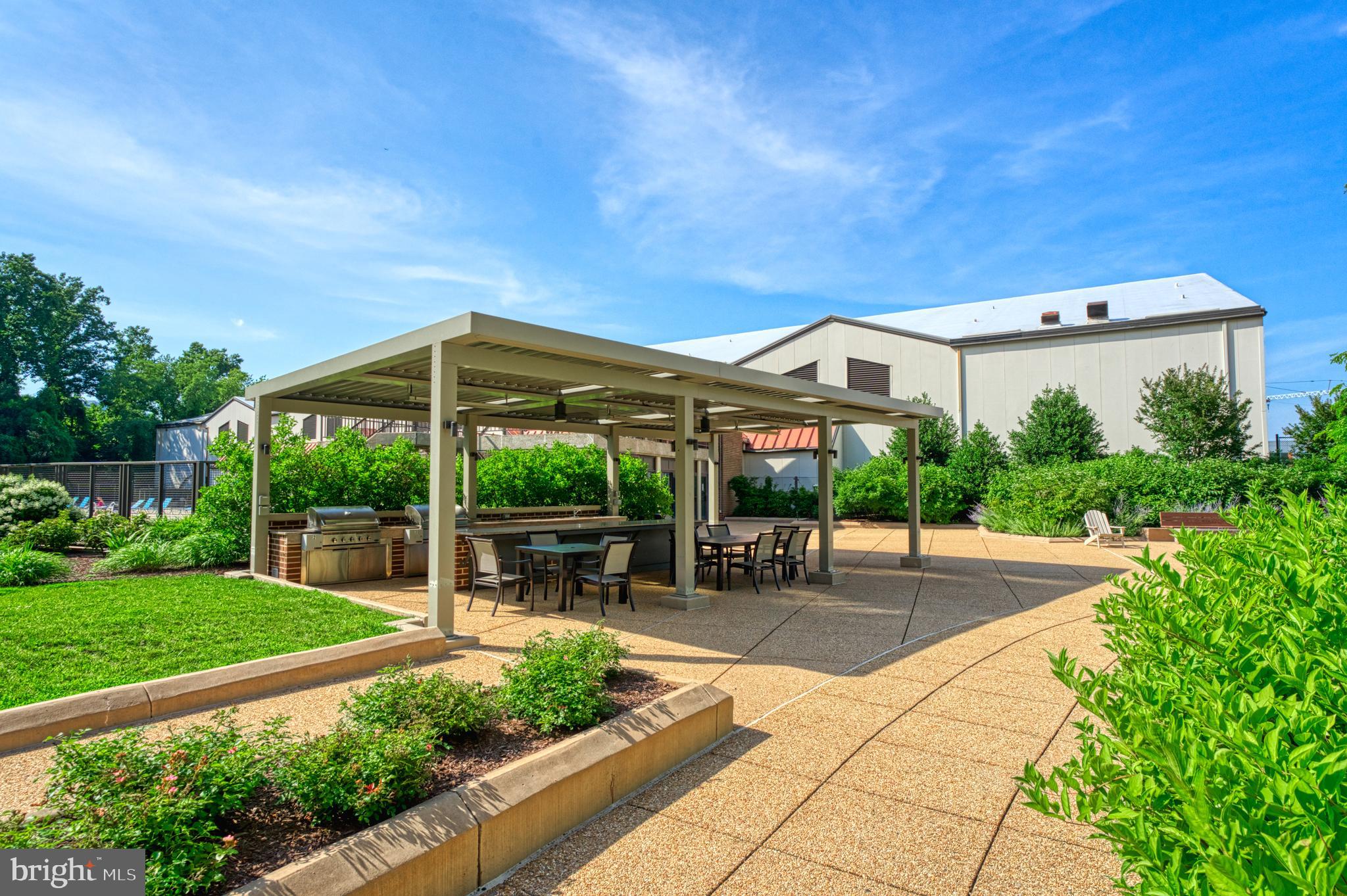 1800 Old Meadow Road, Unit 1006 McLean, VA 22102 - Photo 45 of 63 a view of a patio with a table and chairs under an umbrella