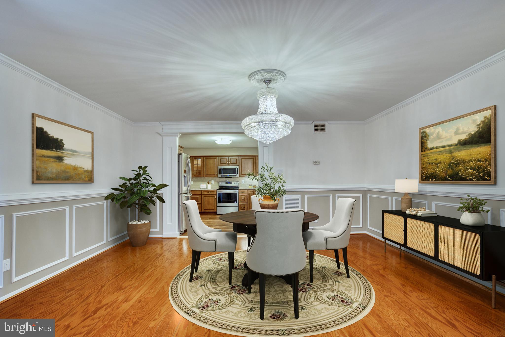 1800 Old Meadow Road, Unit 1006 McLean, VA 22102 - Photo 8 of 63 a dining room with furniture a rug a potted plant and wooden floor