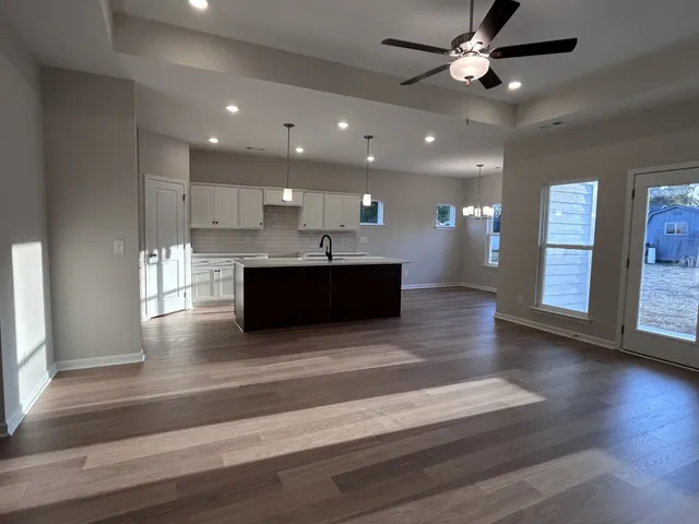 a view of kitchen and hall with wooden floor