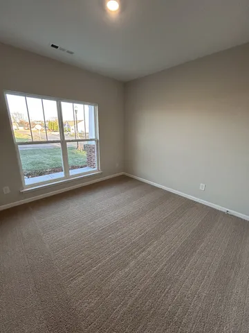 a view of an empty room and closet area