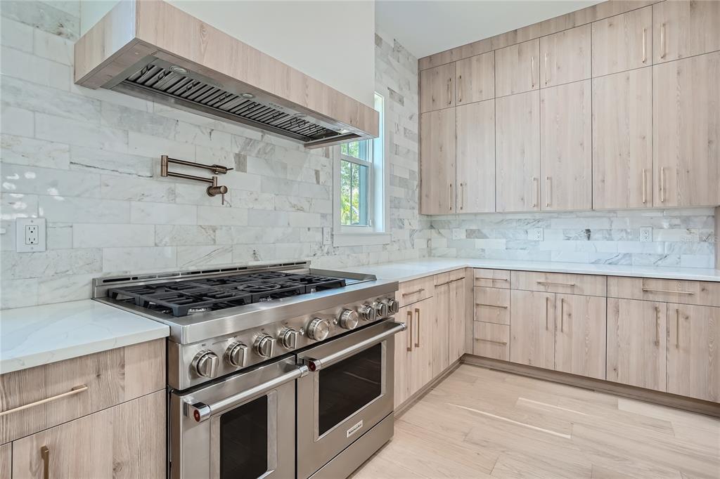 325 33rd Avenue North St. Petersburg, FL 33704 - Photo 15 of 57 a kitchen with granite countertop stainless steel appliances and white cabinets