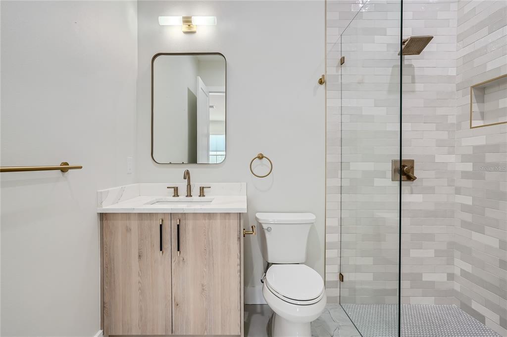 325 33rd Avenue North St. Petersburg, FL 33704 - Photo 20 of 57 a bathroom with a toilet a sink a mirror and shower