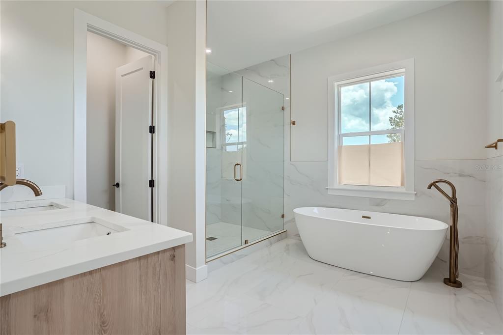 325 33rd Avenue North St. Petersburg, FL 33704 - Photo 24 of 57 a spacious bathroom with a tub sink shower and mirror