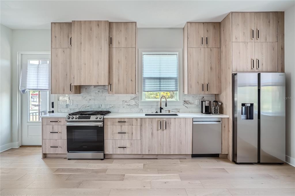 325 33rd Avenue North St. Petersburg, FL 33704 - Photo 45 of 57 a kitchen with white cabinets and stainless steel appliances
