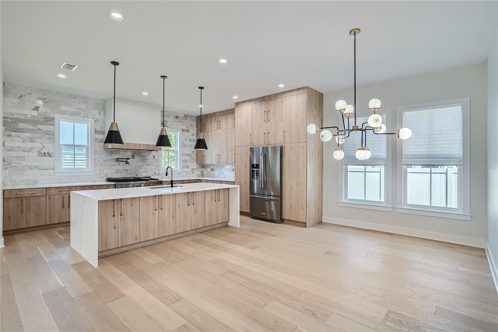 325 33rd Avenue North St. Petersburg, FL 33704 - Photo 10 of 57 a large kitchen with stainless steel appliances kitchen island a large island in the center