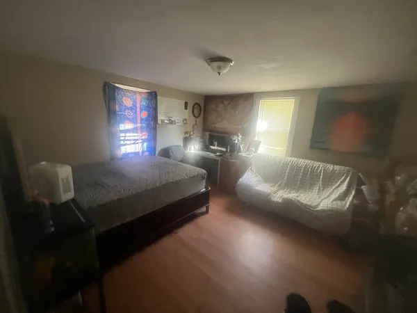 a bedroom with a bed window and lamp
