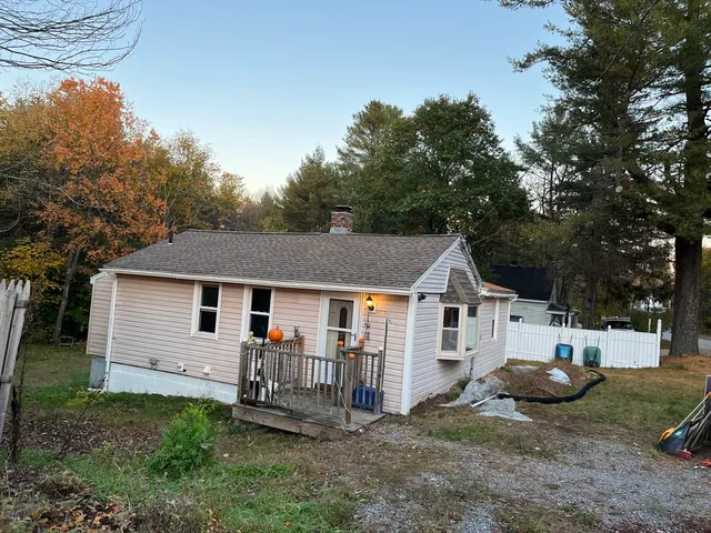 a view of a house with backyard and sitting area