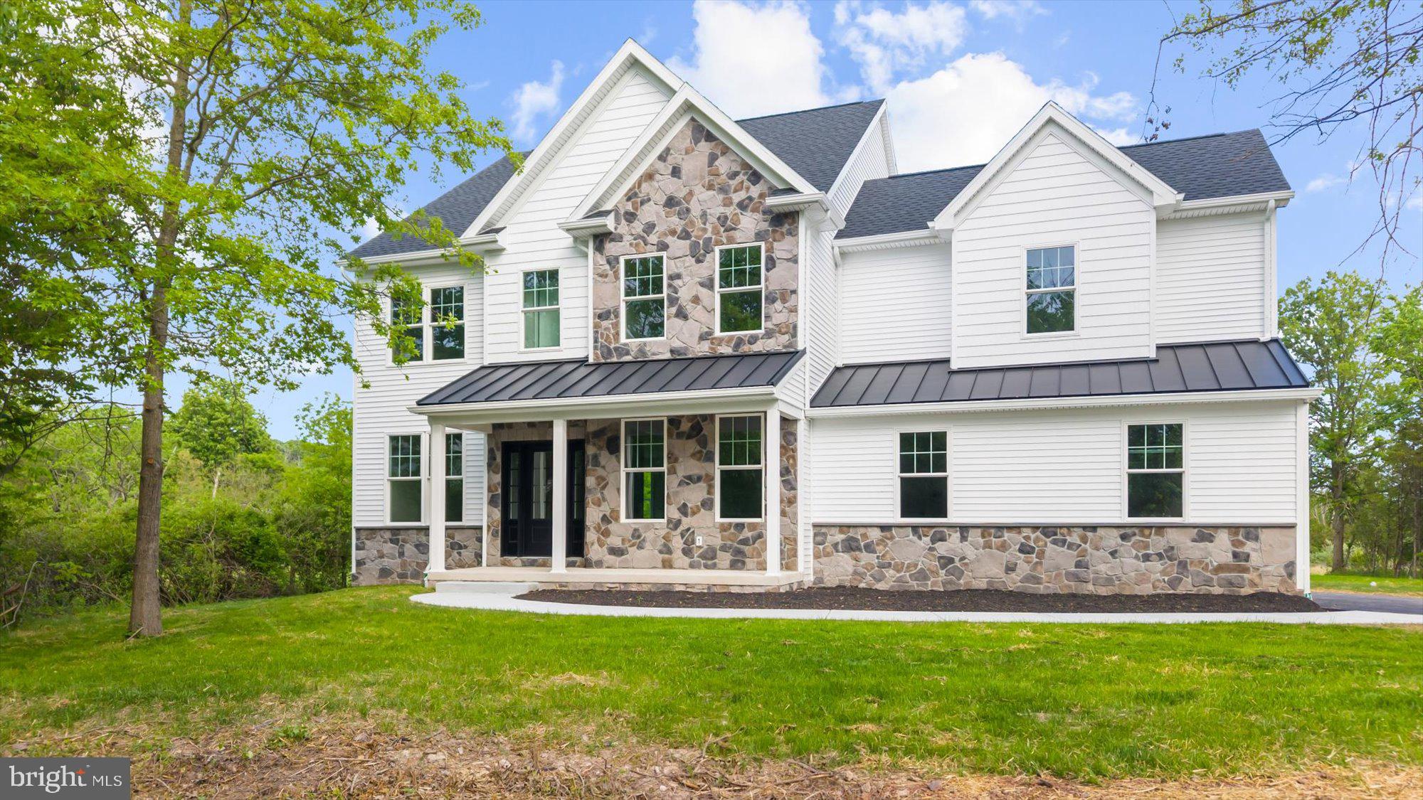 394 Renninger Road Perkiomenville, PA 18074 - Photo 1 of 41 a front view of a house with a garden and yard