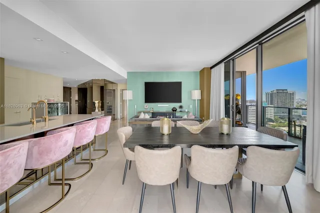 a dining room with furniture and a flat screen tv