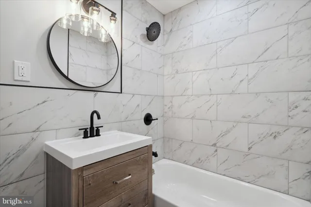 a bathroom with a sink and mirror