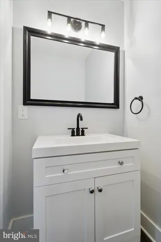 a bathroom with a sink and mirror