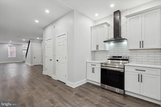 a kitchen with stainless steel appliances granite countertop a stove and a refrigerator