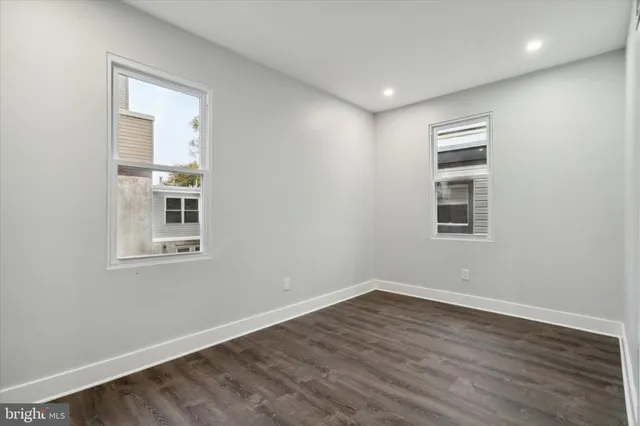a view of a room with wooden floors and window