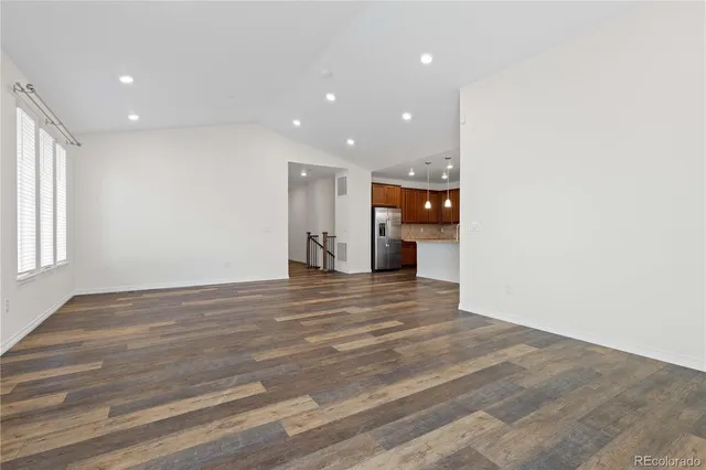 a view of empty room with wooden floor