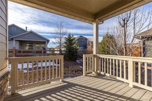 a view of a balcony with wooden floor and glass door