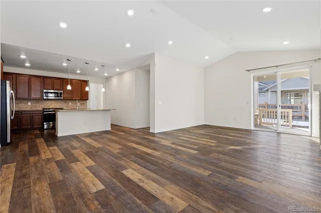 a view of kitchen with kitchen island sink and refrigerator