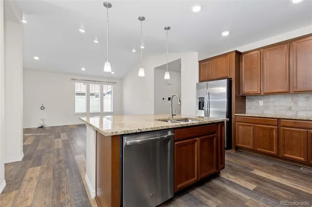 a kitchen with a stove sink and cabinets