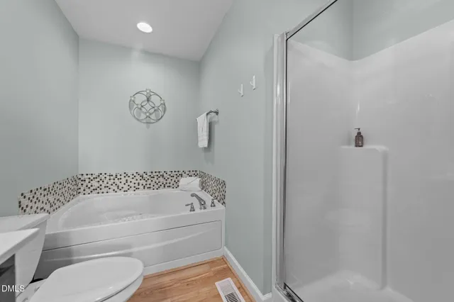 a bathroom with a bathtub and a shower