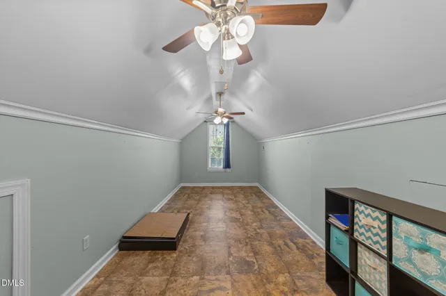 a view of a hallway with a chandelier fan