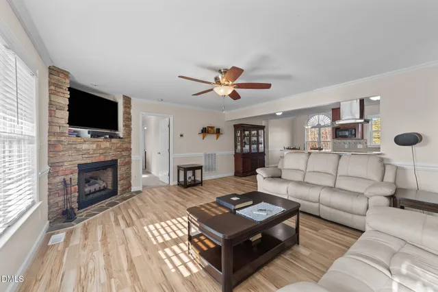 a living room with furniture a fireplace and a flat screen tv