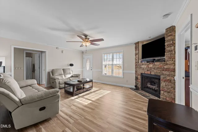 a living room with furniture a fireplace and a flat screen tv