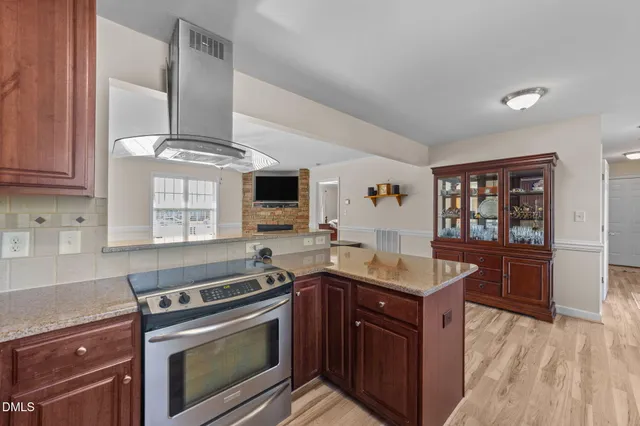 a kitchen with stainless steel appliances granite countertop a stove and a sink