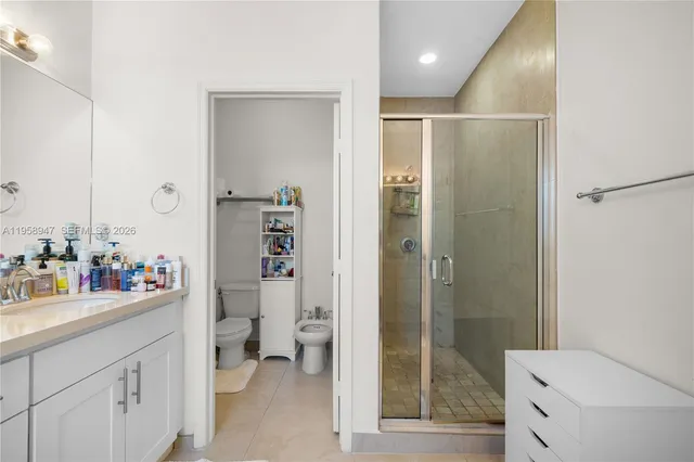 a bathroom with a sink mirror vanity and toilet