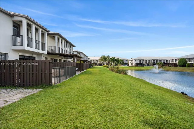 a view of a house with swimming pool and yard