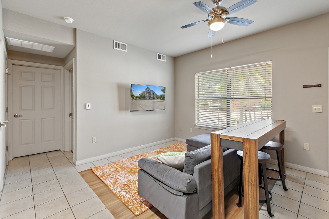 2515 Pearl Street, Unit 102 Austin, TX 78705 - Photo 13 of 30 Living area with light tile patterned floors and a ceiling fan
