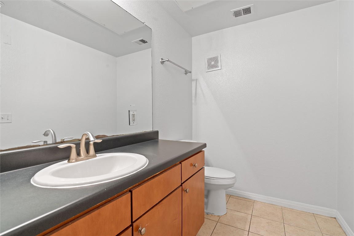 2515 Pearl Street, Unit 102 Austin, TX 78705 - Photo 17 of 30 Half bath with light tile patterned flooring and vanity