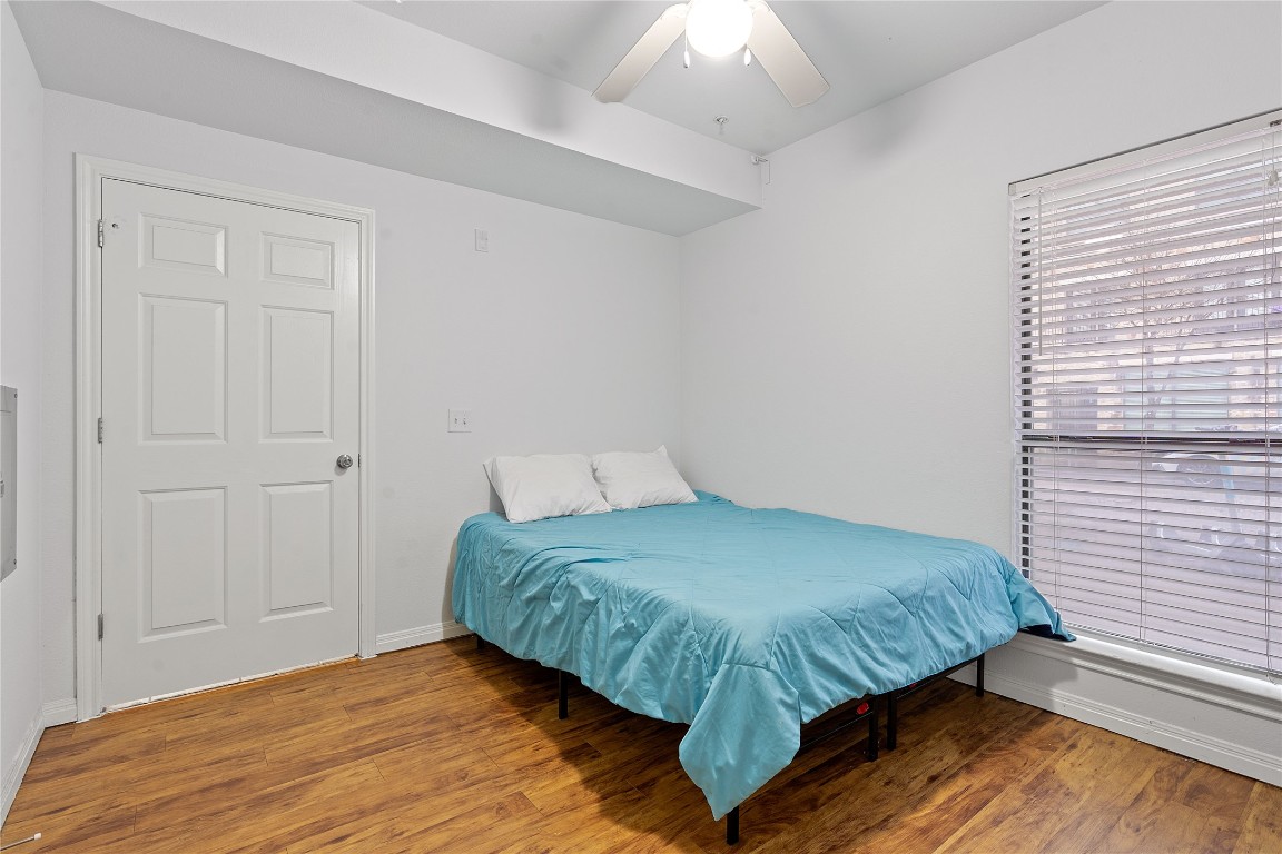 2515 Pearl Street, Unit 102 Austin, TX 78705 - Photo 18 of 30 Bedroom featuring light wood-style flooring and ceiling fan