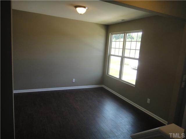 4304 Hargrove Road Raleigh, NC 27604 - Photo 2 of 10 an empty room with wooden floor and windows