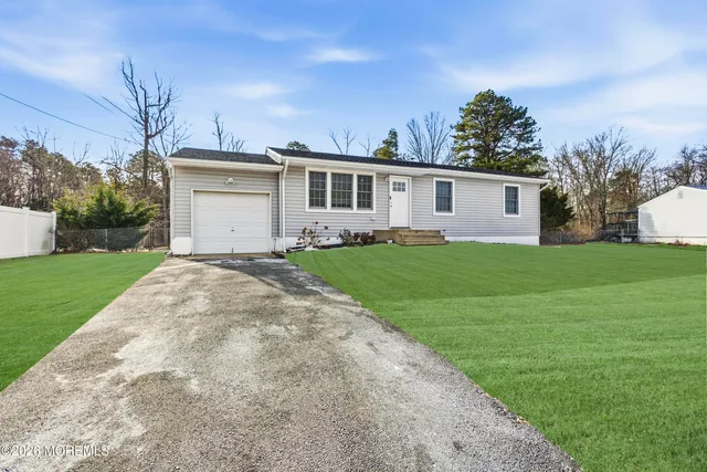 a front view of house with yard and green space