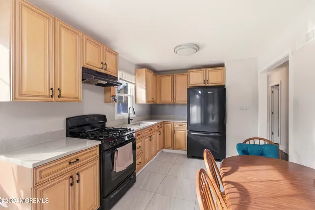 a kitchen with stainless steel appliances granite countertop a refrigerator stove and sink