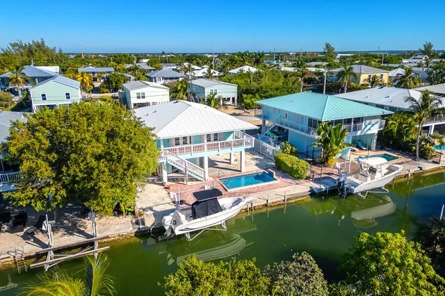 a view of a lake with a house swimming pool and outdoor space