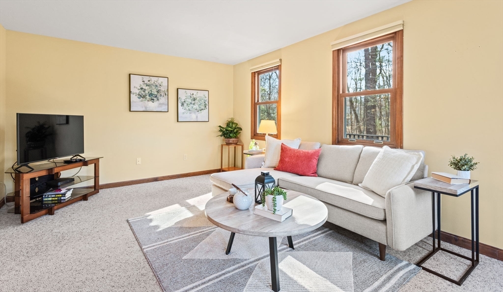 2 Heritage Way Bellingham, MA 02019 - Photo 13 of 31 a living room with furniture and a flat screen tv