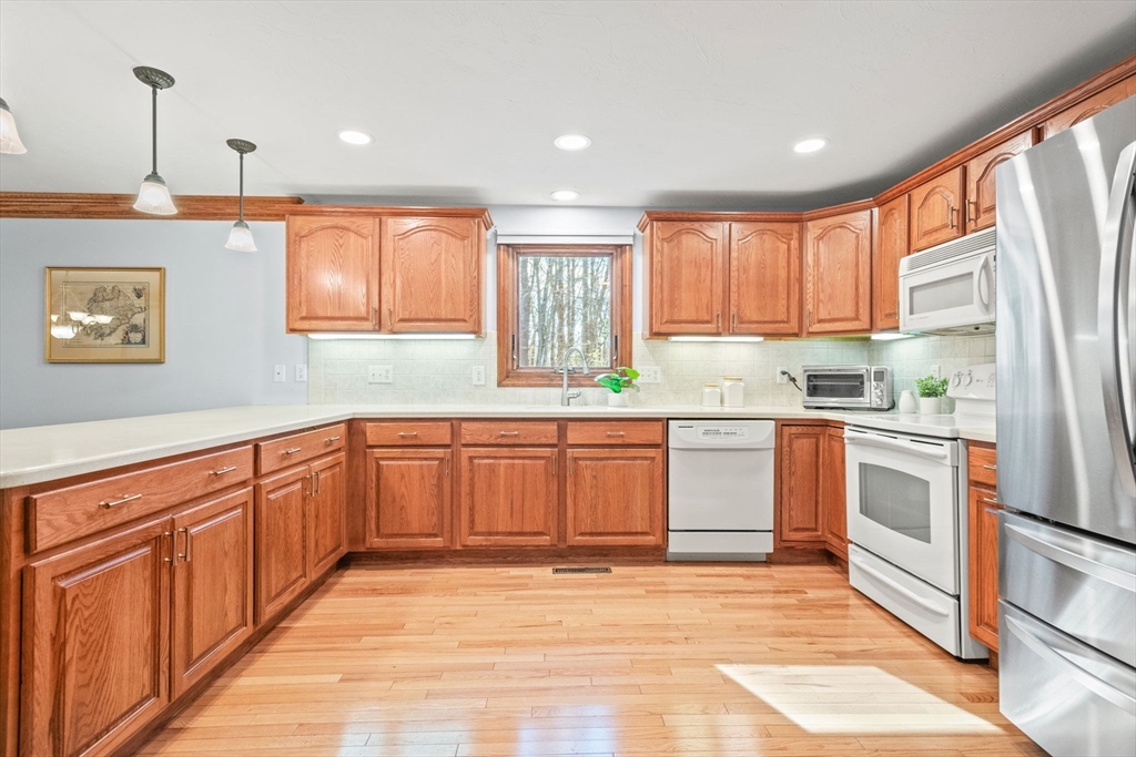 2 Heritage Way Bellingham, MA 02019 - Photo 7 of 31 a kitchen with stainless steel appliances granite countertop a refrigerator sink and cabinets