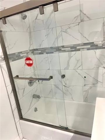 a bathroom with a shower and a sink